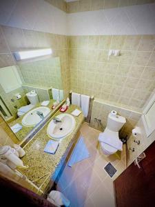 a bathroom with a sink and a toilet at Eagles Downtown Resort in Hurghada