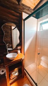 a bathroom with a sink and a glass shower at Piedra que late in Tandil +13 photos