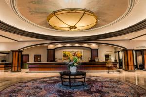 a lobby with a reception desk in a building at Amway Grand Plaza Hotel, Curio Collection by Hilton in Grand Rapids