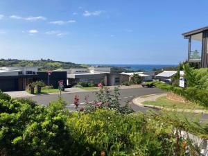 a view of a street with houses and flowers at Sea&Country Kiama - Stunning Views-Relaxing-Spacious-Deck-EVC in Kiama