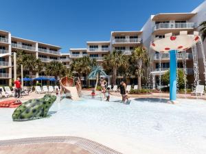 a group of people playing in a pool at a resort at Waterscape C206 Ground Floor in Fort Walton Beach