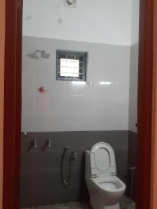 a bathroom with a toilet and a window at Oasis villa in Vagamon