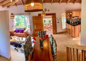 a living room with a wooden table and a kitchen at Villa Tortuga Constanza in Constanza