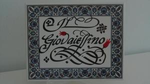 a picture of a painting with calligraphy in a frame at Il Giovaiellino in Belpasso