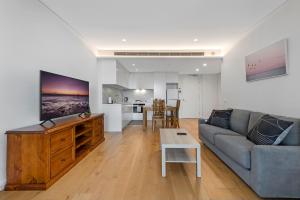 a living room with a couch and a table at Central location one bedroom in Chatswood in Sydney