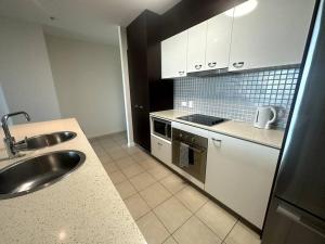 a kitchen with a sink and a counter top at Massive Wings Apartment - 1 Block From Beach in Gold Coast