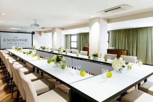 a large conference room with white tables and chairs at The Exchange Sacramento, Curio Collection By Hilton in Sacramento