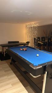 a pool table in a living room with a pool table at 1001 nuits F in Fénay
