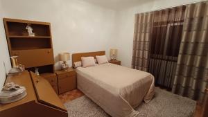 a bedroom with a bed and a dresser and a desk at Orion Guest Villa Casais in Lousada +160 photos