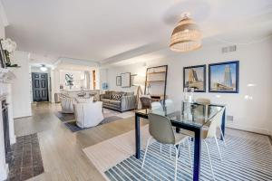 a dining room and living room with a glass table at Chic & Central Foggy Bottom DC Stay in Washington, D.C.