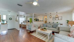 a living room with two couches and a table at Cozy Pet-Friendly Private Pool Near Beaches in Bradenton