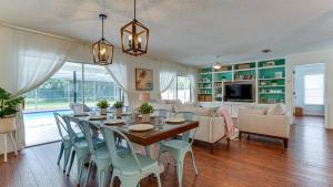 a dining room and living room with a table and chairs at Cozy Pet-Friendly Private Pool Near Beaches in Bradenton