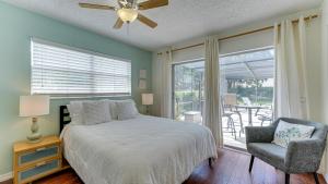 a bedroom with a bed and a chair and a window at Cozy Pet-Friendly Private Pool Near Beaches in Bradenton +37 photos