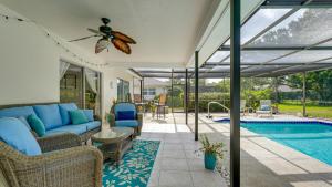 a living room with a couch and a swimming pool at Cozy Pet-Friendly Private Pool Near Beaches in Bradenton