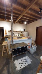 a kitchen with a stove top oven in a room at Skyline Urubici - Barn in Urubici