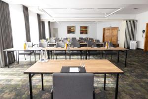 a large room with tables and chairs in it at Hotel Gut Matheshof, BW Signature Collection in Rieden