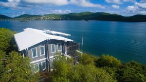 a house on the shore of a large body of water at Ocean Front Villa 2 in Culebra