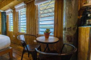 a small table and chairs in a room with a window at Ocean Front Villa 4 Studio in Culebra