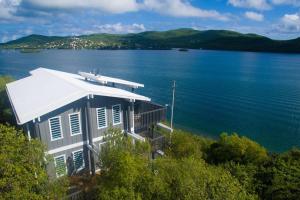 a house on the shore of a large body of water at Ocean Front Villa 4 Studio in Culebra