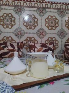 una mesa con platos, jarras y vasos. en House in Rabat medina best vibe en Rabat