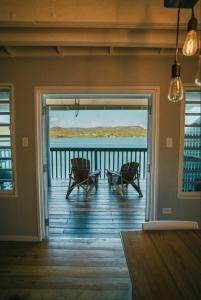 a porch with two chairs and a view of the water at Ocean Front Villa 1 in Culebra