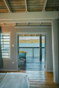 a bedroom with a bed and a view of the ocean at Ocean Front Villa 1 in Culebra