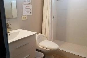 a bathroom with a toilet and a sink and a shower at Ocean Front Villa 1 in Culebra
