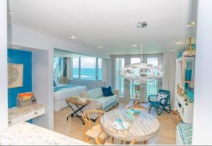 a living room with a table and a couch at Enchanted Honeymoon Isla Verde Beachfront in San Juan