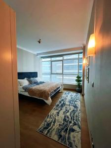 a bedroom with a bed and a large window at شقة فندقية - كورنيش المعادي تاور ريزيدنت in Cairo
