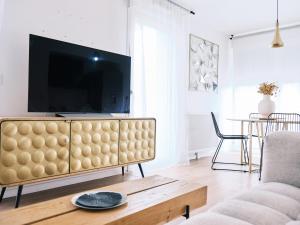 Et tv og/eller underholdning på Bel appart familial avec terrasse aux portes de Paris - Parking gratuit