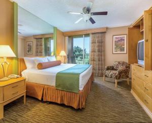 a hotel room with a bed and a television at WorldMark Palm Springs - Plaza Resort and Spa in Palm Springs