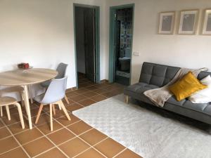 a living room with a couch and a table at Quinta da Casa Azul in Óbidos +12 photos