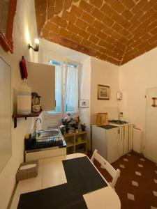 a kitchen with a table and a kitchen with a stove at George’s House in Florence