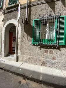 a building with a green window and a door at George’s House in Florence
