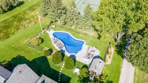 an aerial view of a house with a swimming pool at Mountain Ash Country Manor and Spa in Creemore