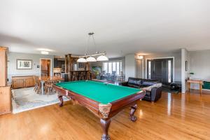 a living room with a pool table in it at Mountain Ash Farm Country Manor in Creemore