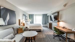 a hotel room with a couch and a bed at Staybridge Suites Dallas Market Ctr Love Field by IHG in Dallas