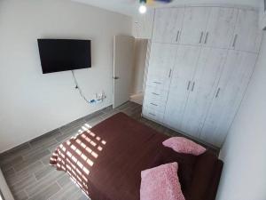 a bedroom with a bed and a flat screen tv at Vivienda completa. Privada con acceso controlado. FACTURAMOS in Hermosillo