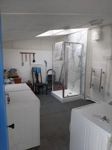 a room with a glass shower in a room at Tawleat in Okehampton