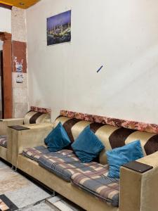 a couch sitting in a room with blue pillows at البديل الاول 1 in Al Madinah