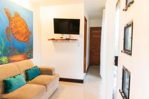 a living room with a couch and a flat screen tv at Summer Deals! 800M to Samara Beach 2 BDR in Sámara