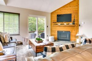 a living room with a fireplace and a tv at Somerset Townhome with Deck Less Than 2 Mi to Ski Lift! in Champion