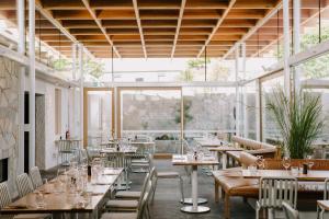 a restaurant with tables and chairs and windows at Shipwrights Arms Hotel in Hobart
