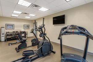 a gym with cardio machines and a flat screen tv at Garner Hotel Clarksville Northeast, an IHG Hotel in Clarksville