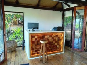 a bar in a room with a stool next to it at Kawai Duli Bungalows in El Nido