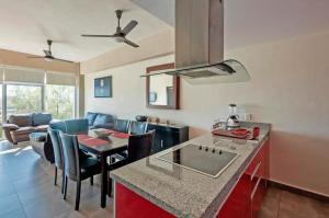 a kitchen and living room with a table and chairs at Departamento en Nuevo Vallarta in Nuevo Vallarta