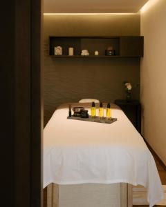 a room with a bed with a tray of drinks on it at Casa 63 Hotel Boutique & Spa - Adults Only in San Miguel de Allende