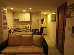 a living room with a couch and a kitchen at Moderno Mono Ambiente céntrico in Santiago del Estero +3 photos