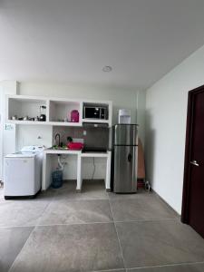 a kitchen with a desk and a refrigerator in a room at Departamento PYO in Mexico City