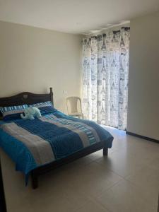 Un dormitorio con una cama con un osito de peluche. en Hermoso departamento amplio, en Tarija